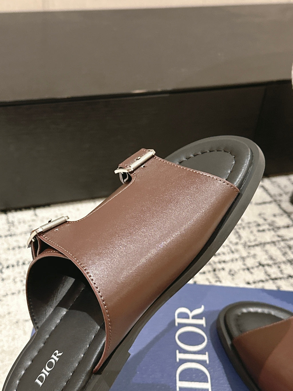 Dior brown leather slide sandal close-up of toe opening and top buckle strap