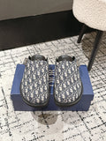 Dior slide sandals with blue-and-white Oblique print and black rubber sole