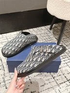Dior slide sandals with Oblique monogram pattern, black trim, flat rubber sole