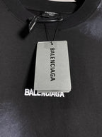 Balenciaga dark T-shirt neckline with brand tag and fabric texture detail