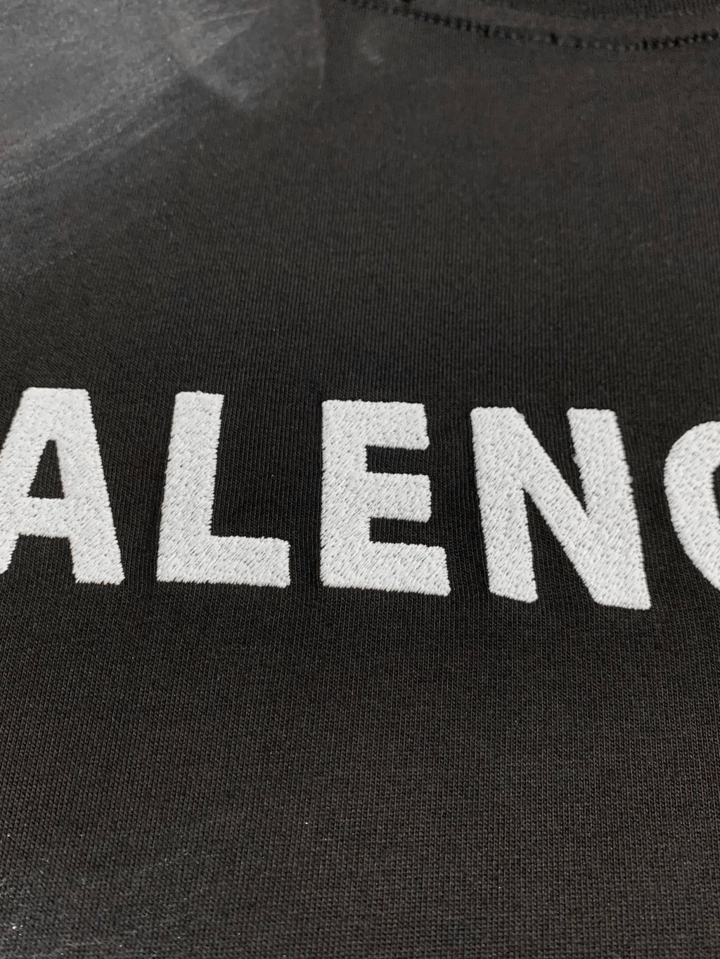 Balenciaga dark T-shirt close-up of large front logo letters