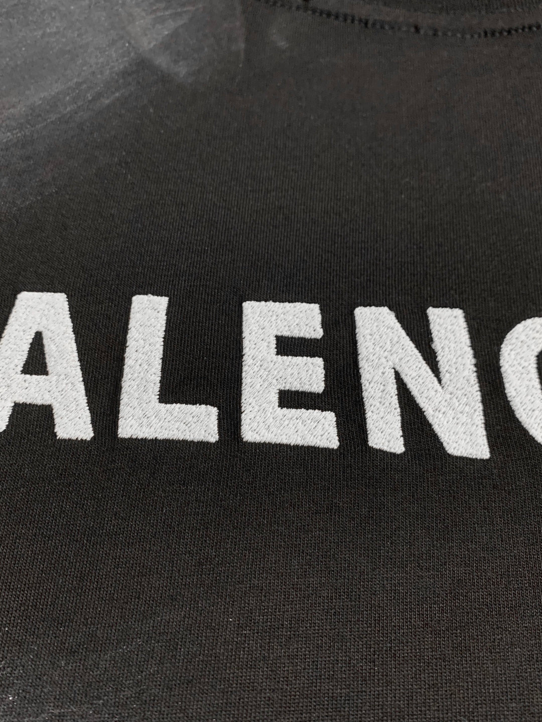 Balenciaga dark T-shirt close-up of large front logo letters