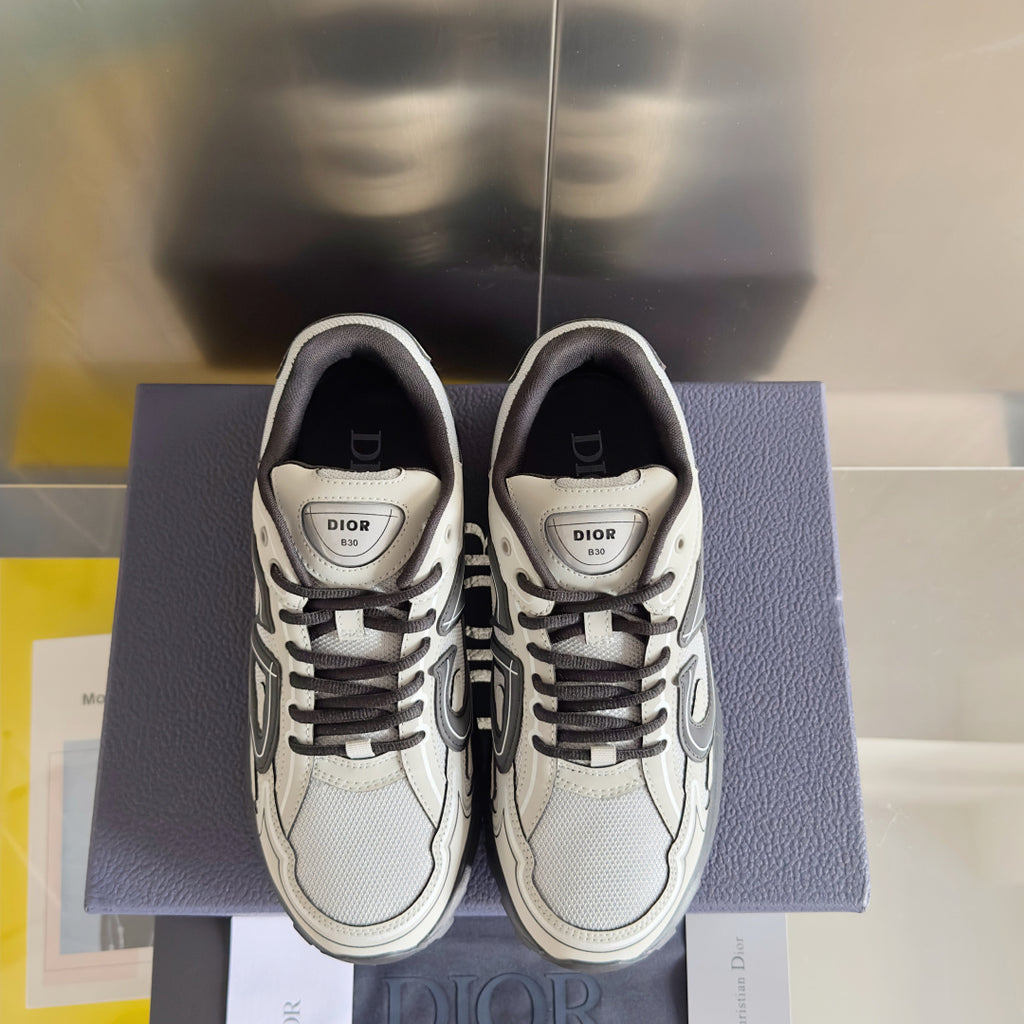 Dior unisex sneakers front view with white uppers, gray laces, and logo tongue patch