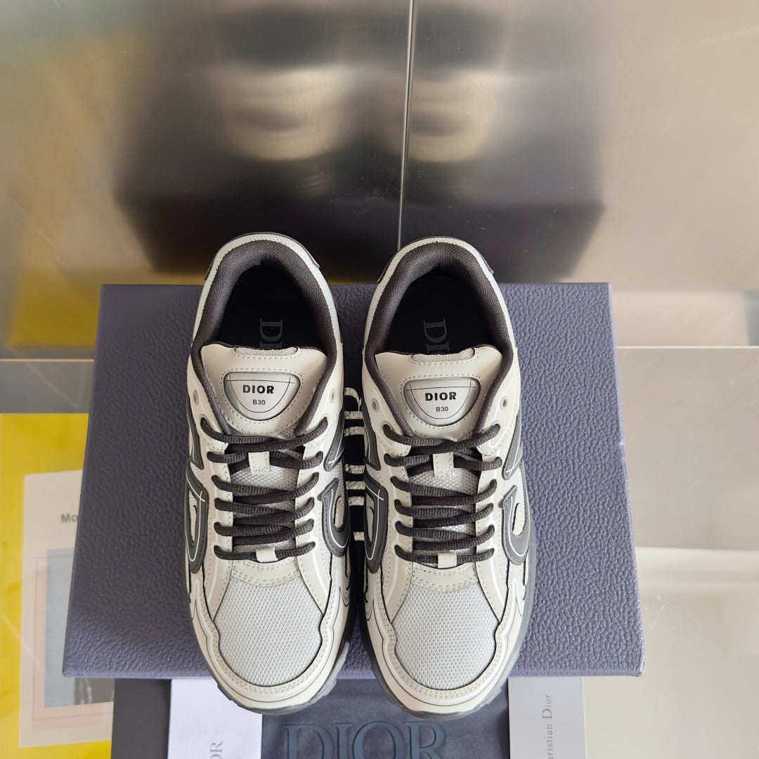 Dior unisex sneakers front view with white uppers, gray laces, and logo tongue patch