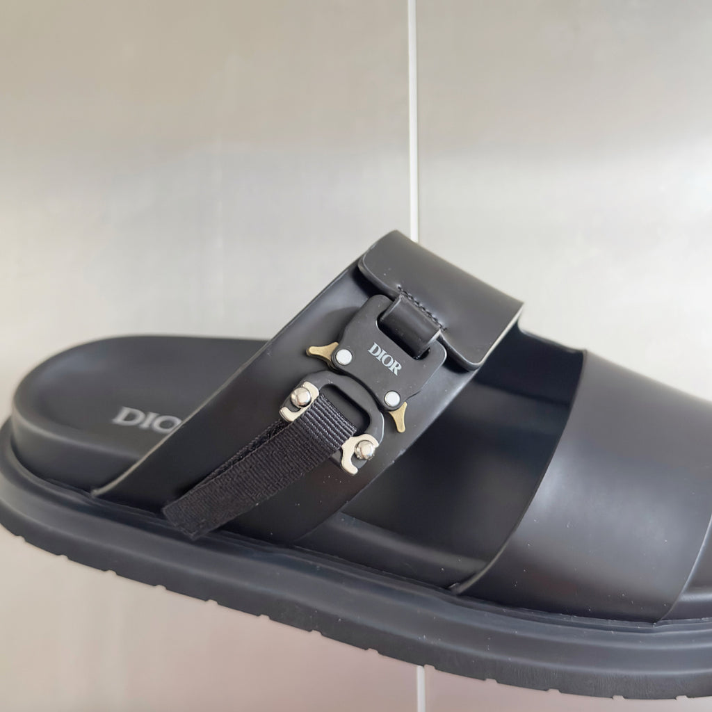 Black Dior sandal with adjustable fabric strap and gold-tone buckle on slide