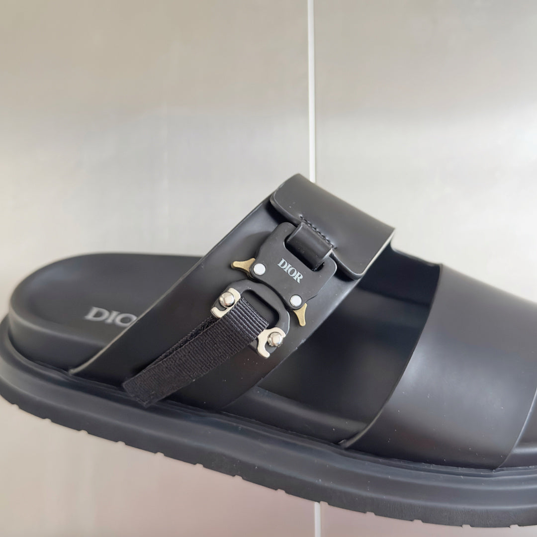 Black Dior sandal with adjustable fabric strap and gold-tone buckle on slide