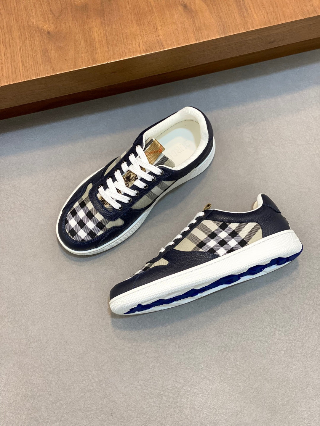 Navy and black-and-white check low-top sneakers with white laces and cup sole