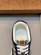Navy sneaker toe view with white laces and check-pattern quarter panel