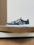Navy-and-white low-top sneakers with check-pattern side panels and white rubber sole