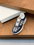 Navy lace-up sneakers with check-pattern side panels and white rubber sole