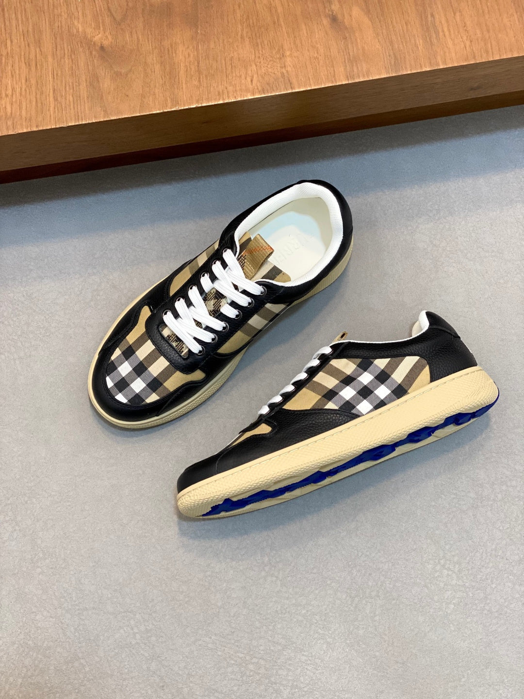 Sneakers on display: navy and beige check panels with white laces and low sole