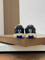 Sneakers back view with blue tread detail and textured beige soles