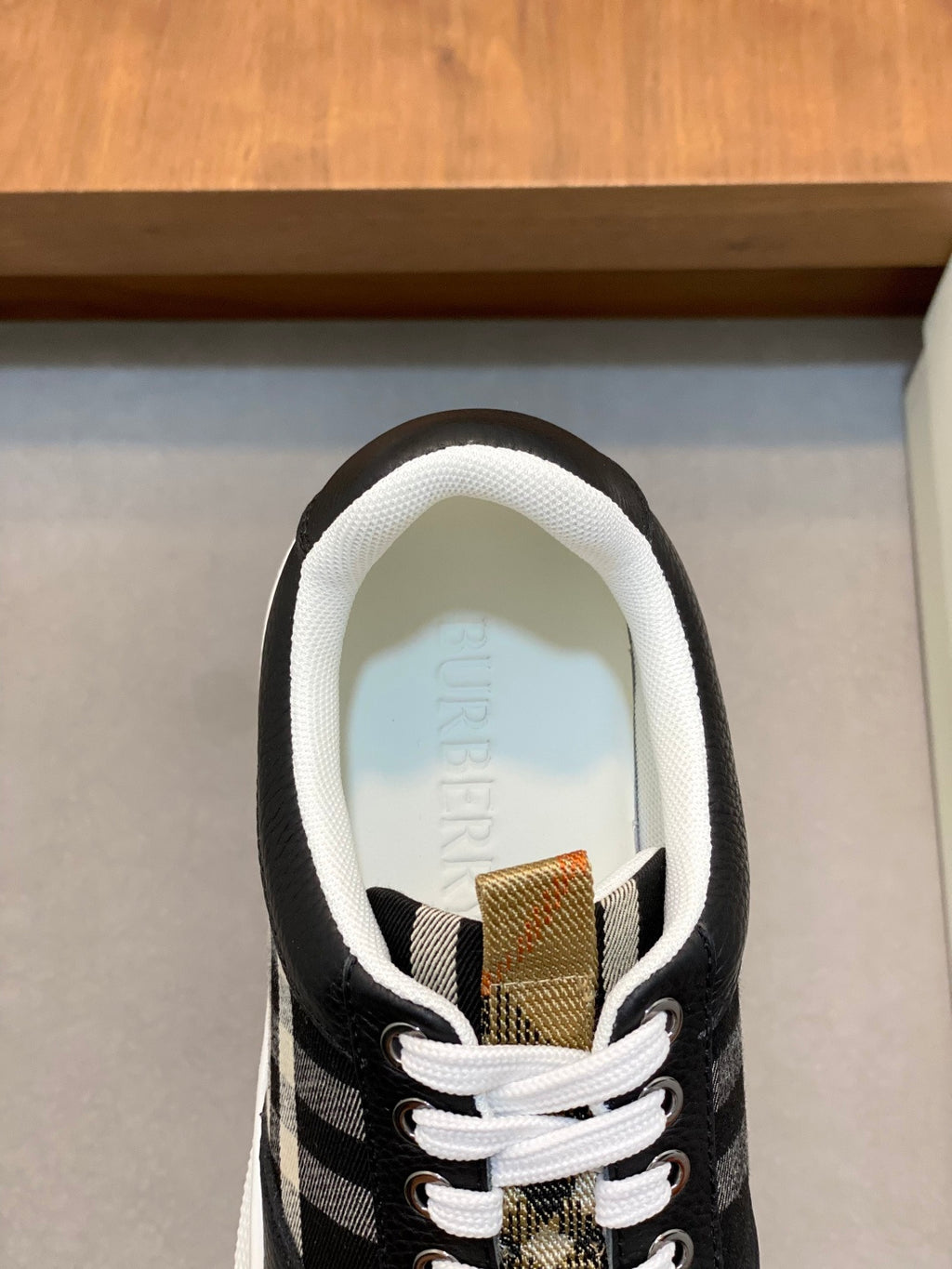 Burberry sneakers close-up, striped tongue and white lace-up front