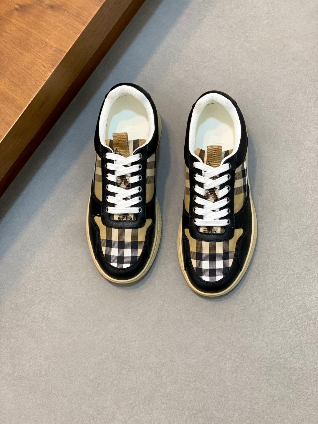 Navy sneakers with white laces, check toe and side panels, and textured sole