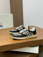 Navy low-top sneakers with white laces and black, beige check side panels