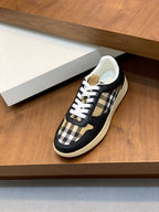 Navy-and-beige check sneakers with white laces on a display shelf
