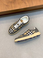 Burberry sneakers with black-and-tan check quarter panels, white laces, and beige sole