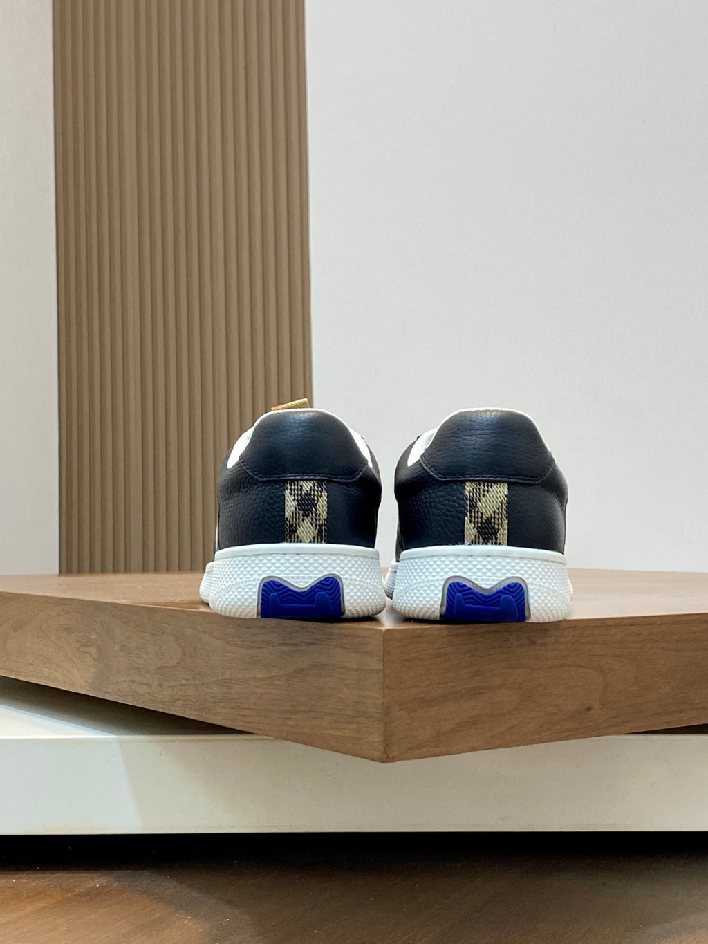 Burberry sneakers back view, black uppers with blue heel tab, white sole