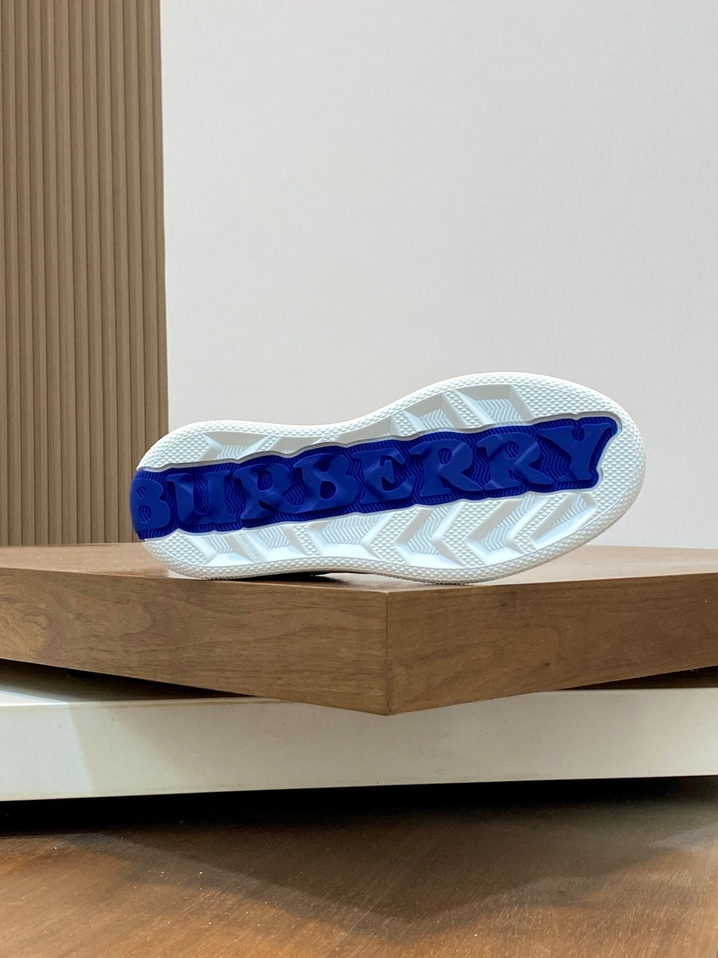 Burberry sneaker outsole, textured white tread with blue lettering