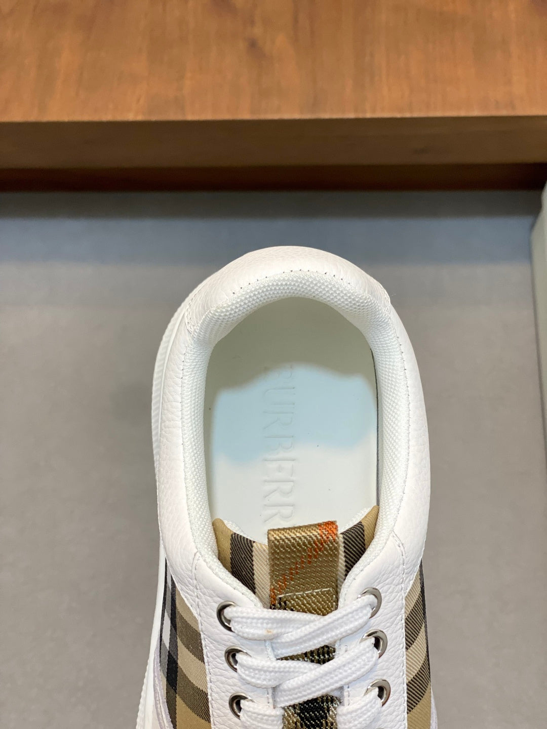 Burberry low-top sneaker tongue and lace area with white and black-and-brown check
