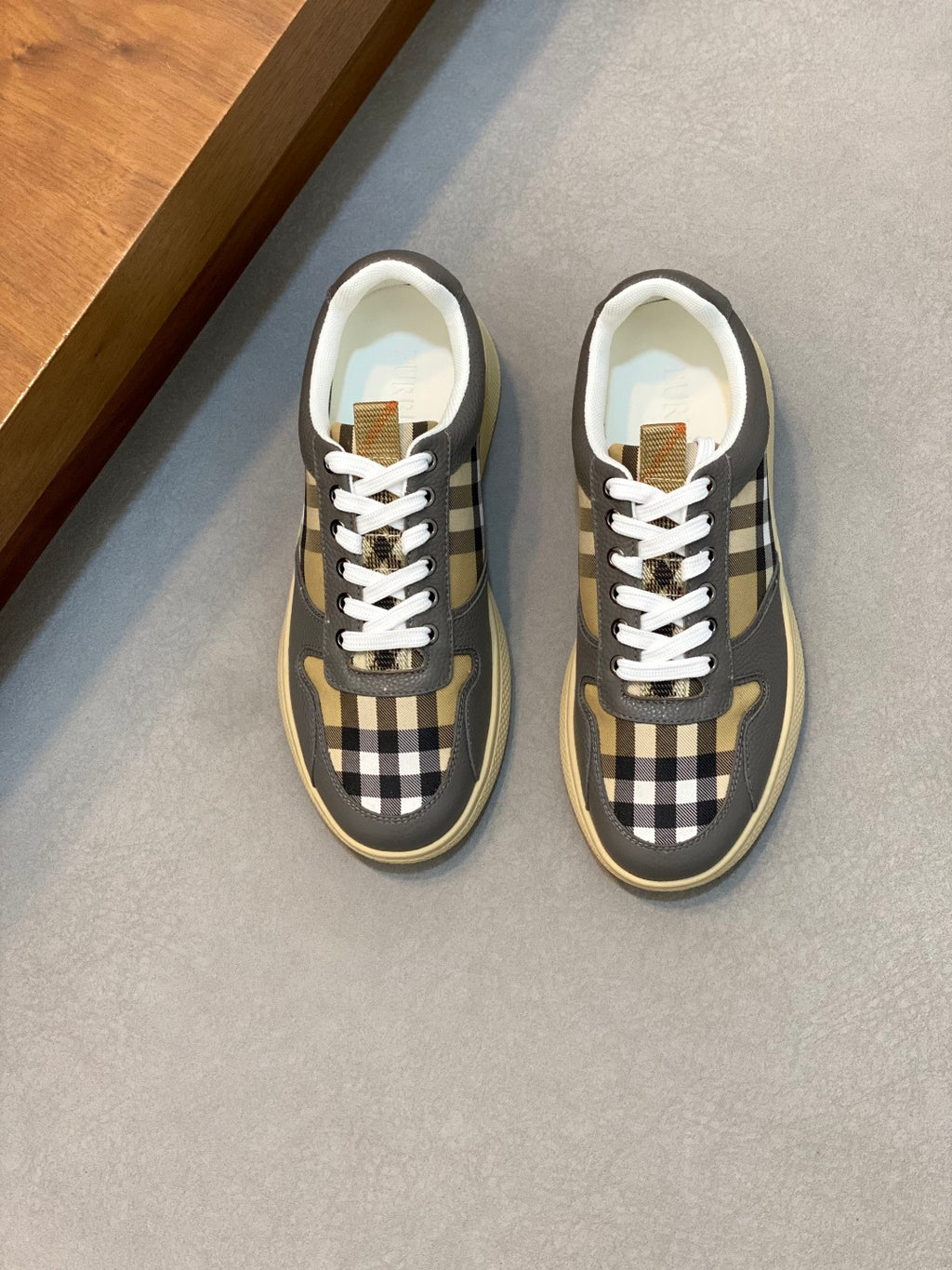 Burberry low-top sneakers in dark gray with tan and black check panels, white laces