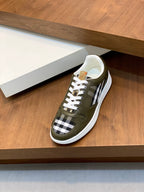 Burberry luxury sneakers on display, olive green with check side stripes