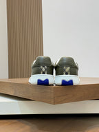 Burberry luxury sneakers back view, olive green with blue heel accents