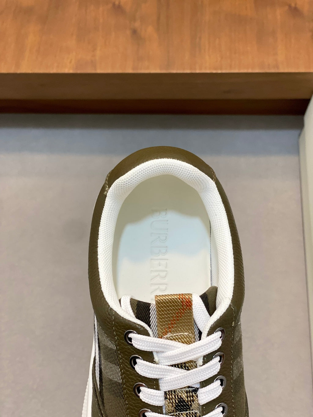 Burberry luxury sneaker upper, olive green lace-up front with check accents