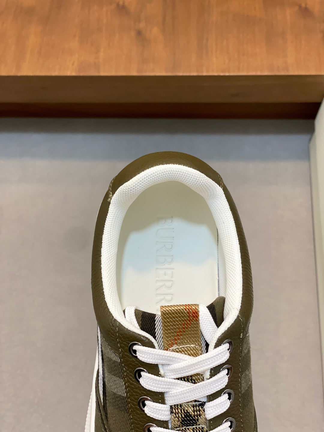 Burberry luxury sneaker upper, olive green lace-up front with check accents