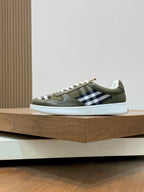 Olive low-top sneaker with white laces and black-and-white check side panel