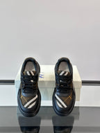 Back view of dark navy lace-up sneakers with beige plaid interior panel