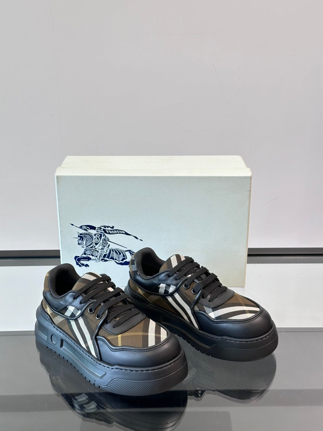 Two-tone lace-up sneakers in dark navy with beige plaid and white stripe detail