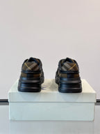 Heel view of dark navy lace-up sneakers with beige plaid stripe detail