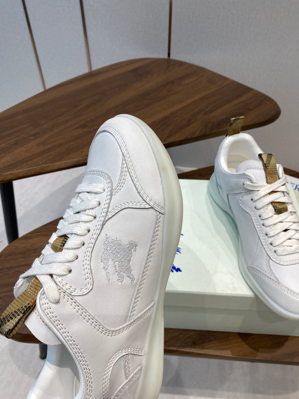 Burberry white leather sneakers side profile with gold-tone trim and lace-up