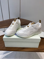 Burberry white leather sneakers, angled view, lace-up and gold-tone heel tabs