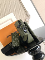 Olive green crossbody bag with adjustable strap, front pocket and metal buckle detail