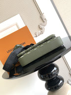 Olive green flap crossbody bag with white monogram pattern, front pocket and strap
