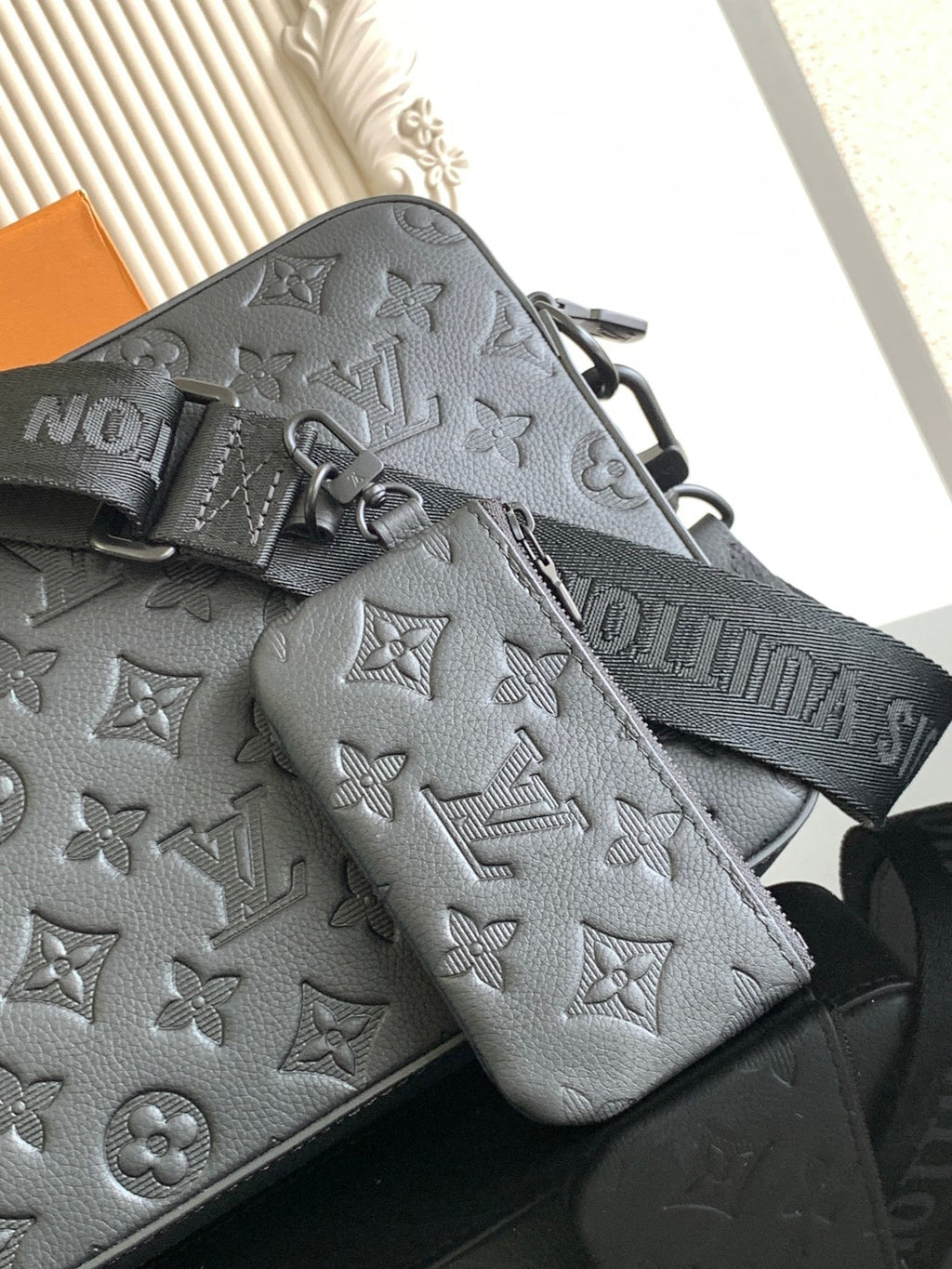 Monogram crossbody bag with zip pocket and attached pouch, dark leather.