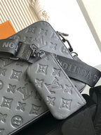 Monogram crossbody bag with zip pocket and attached pouch, dark leather.