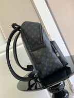 Louis Vuitton monogram backpack side view with zip pocket and adjustable strap