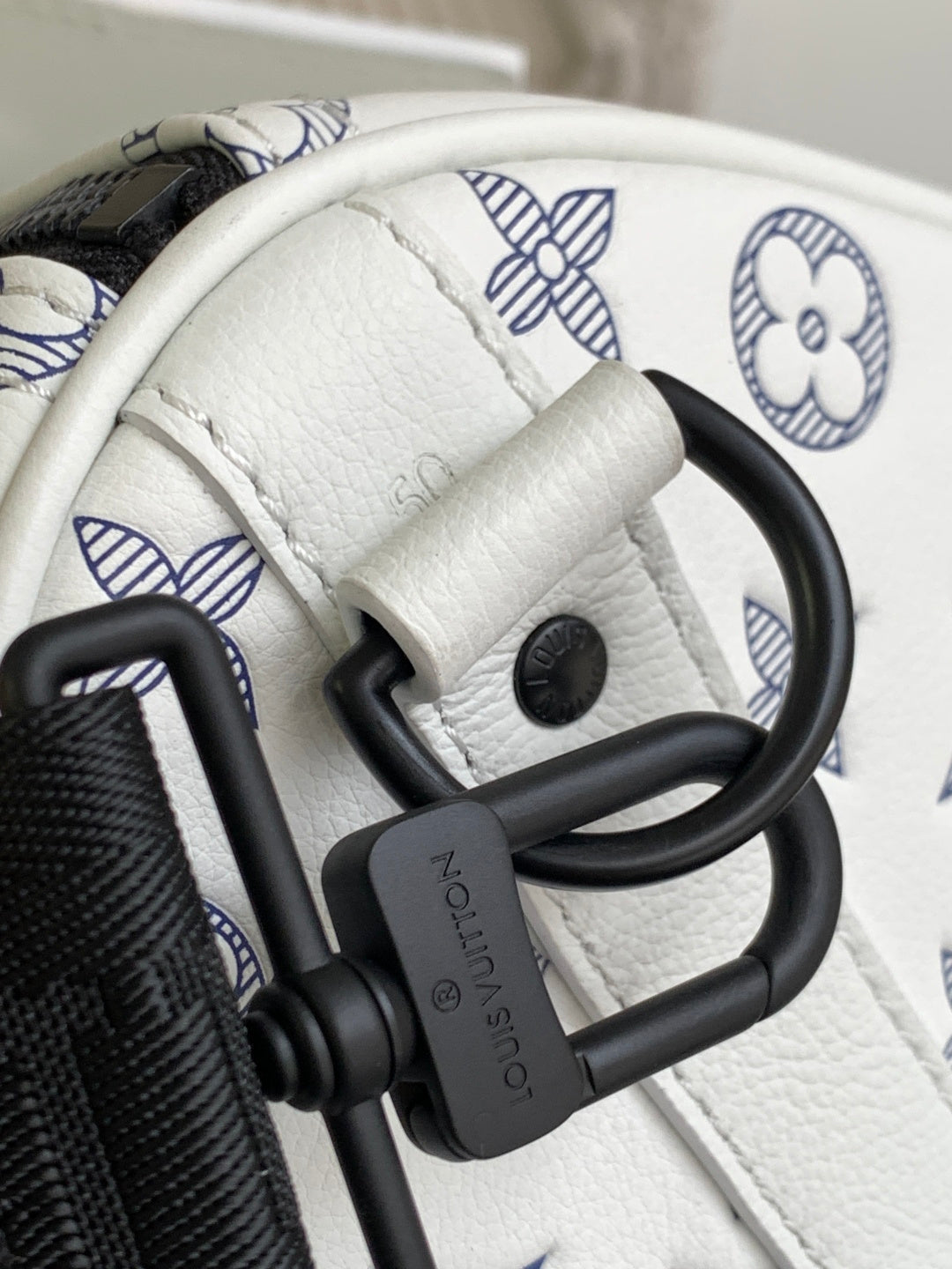 Louis Vuitton monogram bag hardware, black clasp on white leather trim