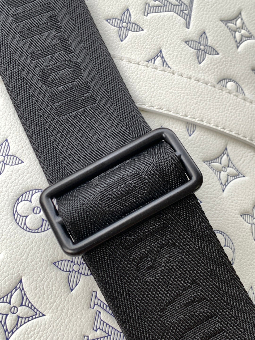 Louis Vuitton monogram bag strap, black textured webbing with embossed pattern
