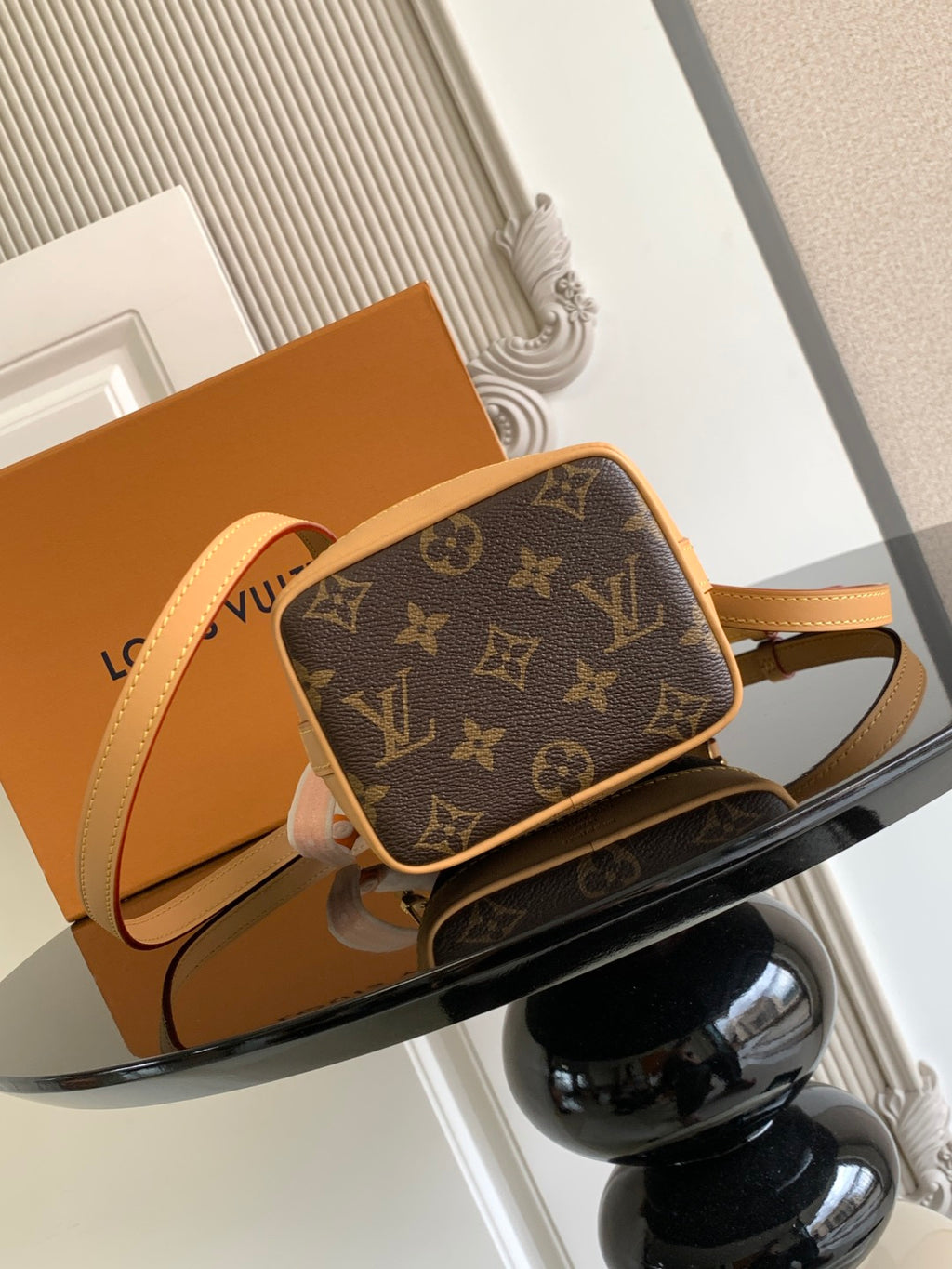 Louis Vuitton monogram crossbody bag with tan trim and adjustable strap