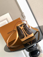 Louis Vuitton monogram bucket bag with tan straps and drawstring top