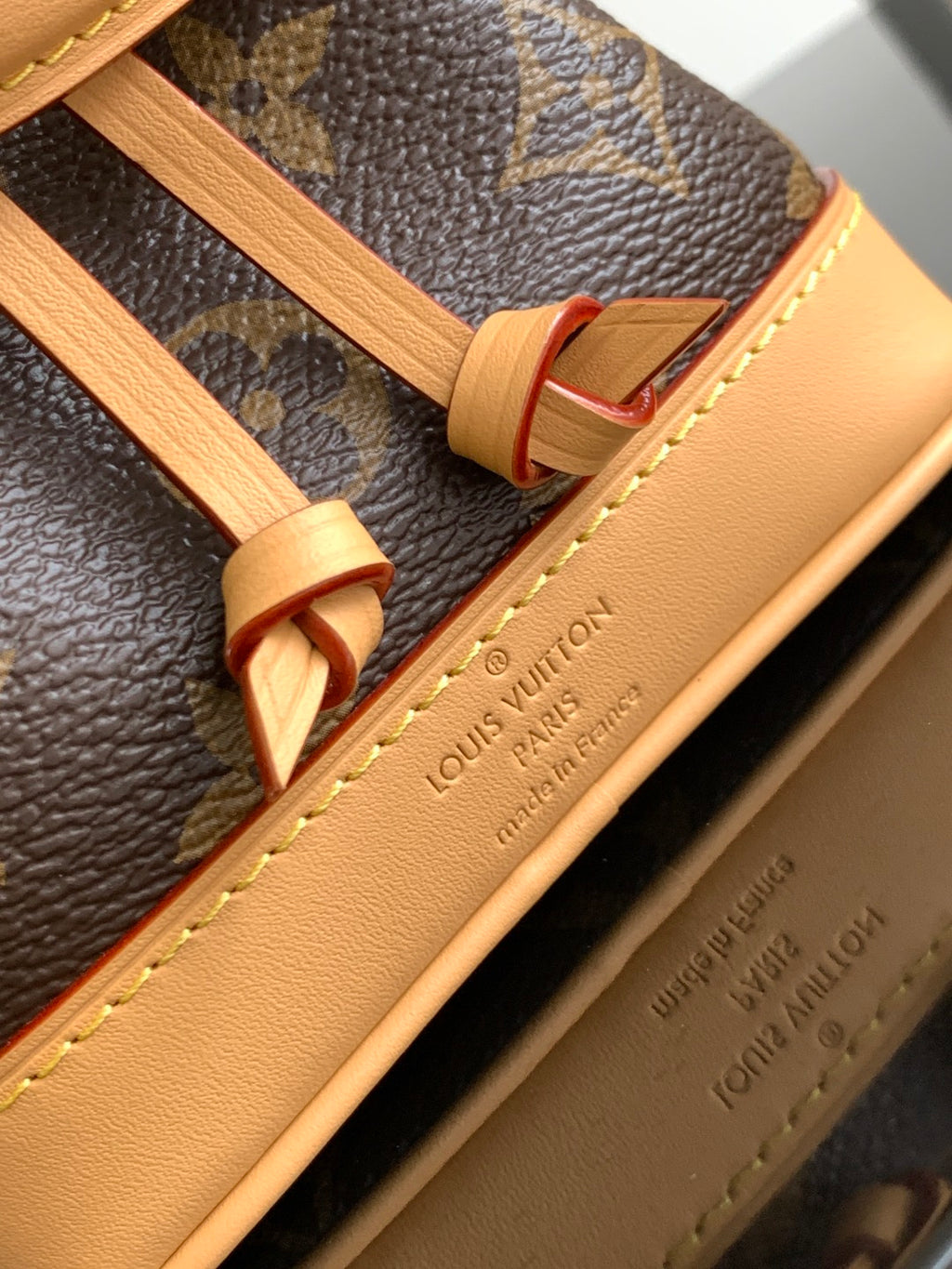 Louis Vuitton monogram bag strap with tan leather trim and engraved text