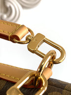 Louis Vuitton bag clasp with gold-tone metal hardware and tan leather strap