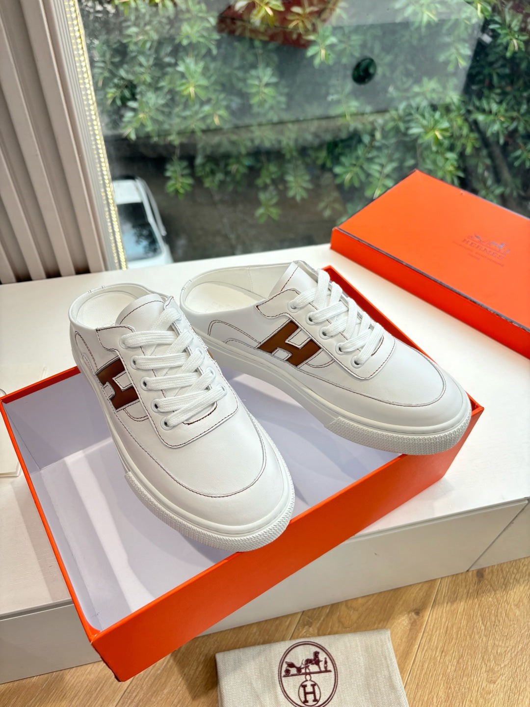 White Hermes sneakers for ladies with brown H logo, lace-up design