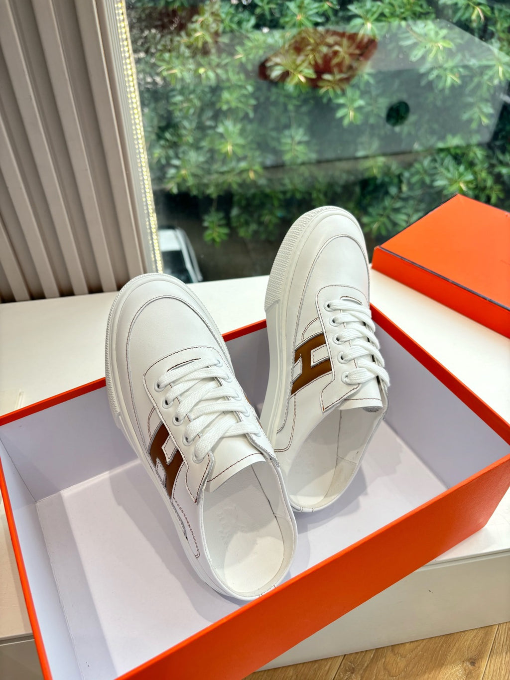 White Hermes sneakers for ladies, side view with brown H detail and laces