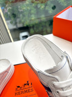 White sneaker interior view with gray lining and stitched trim edges