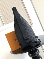 Louis Vuitton bag angled view with top handle and dark embossed monogram pattern